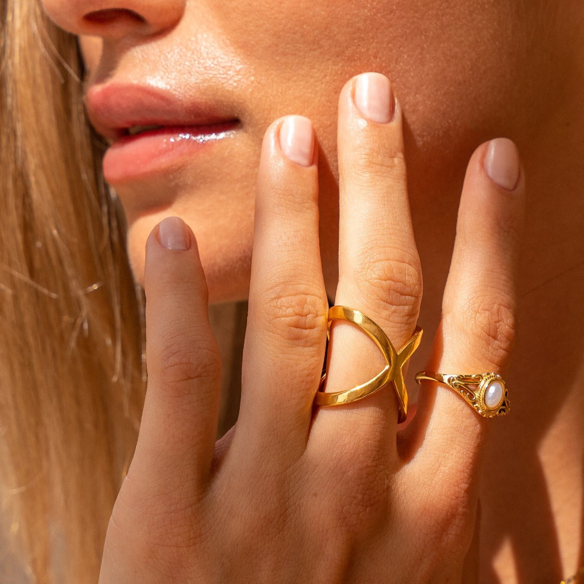 X-shaped ring plated in 18K gold.