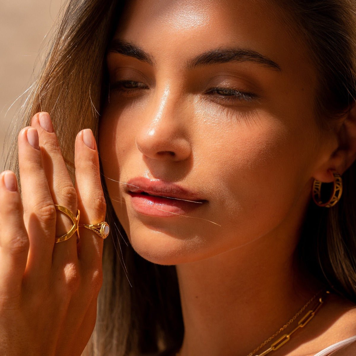 X-shaped ring plated in 18K gold.