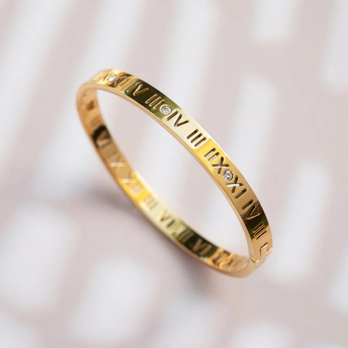 Roman numeral bracelet plated in 18K gold.